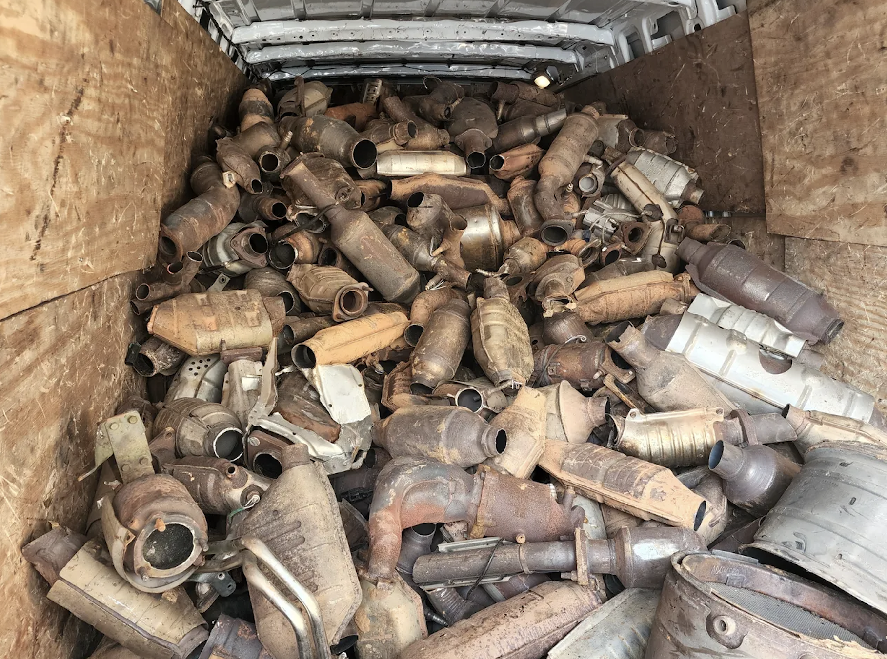 crate full of used catalytic converters