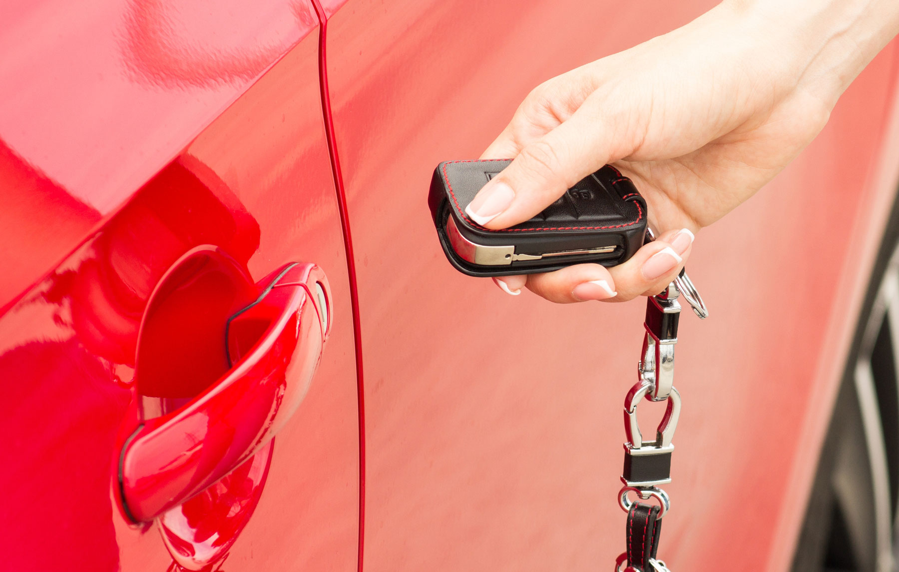 woman unlocking a car with key fob