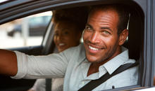 man and woman sitting in a car